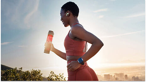 girl running with a sports drink