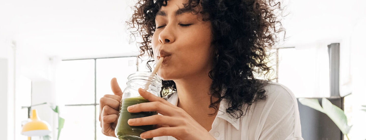 girl drinking green smoothie