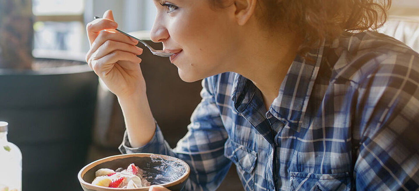 Woman eating a smoothie bowl