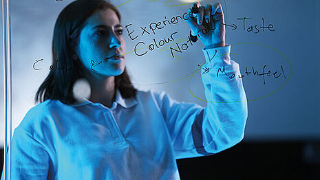 Woman writing on a board