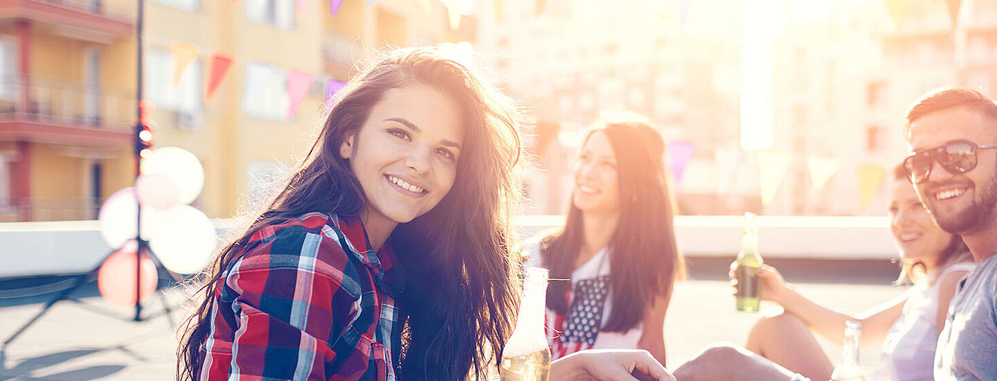 friends on a rooftop consuming soft drinks