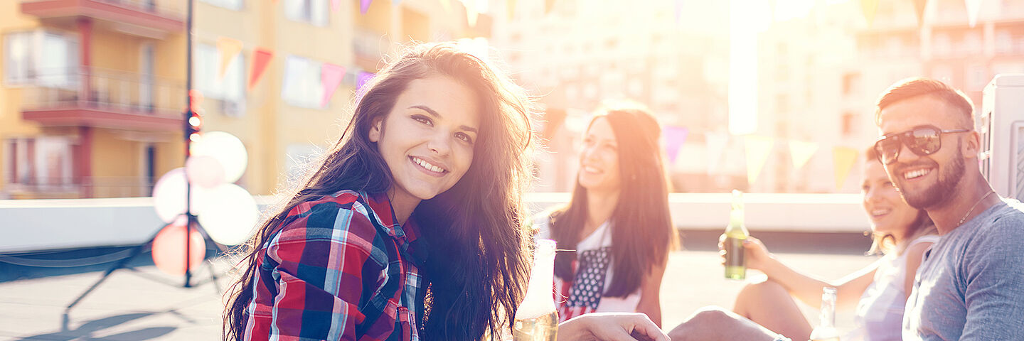 friends on a rooftop consuming soft drinks