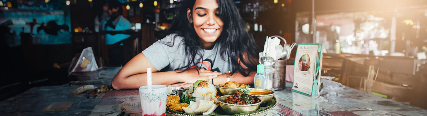 mulher comendo comida indiana