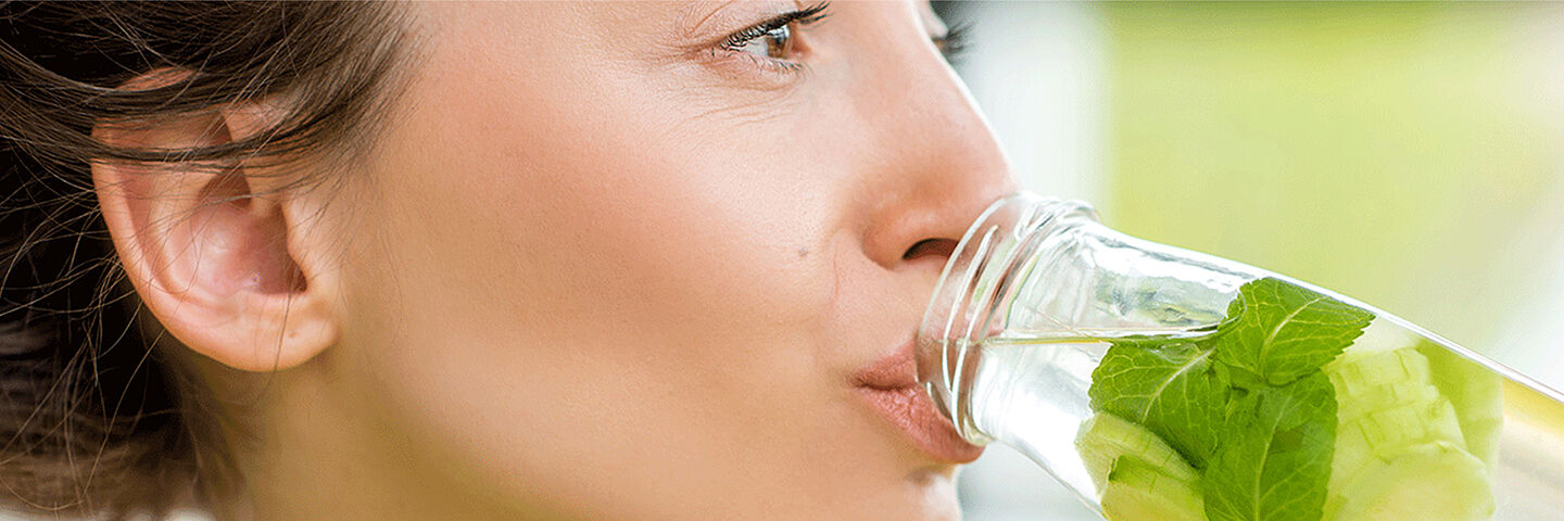 woman drinking water with mint