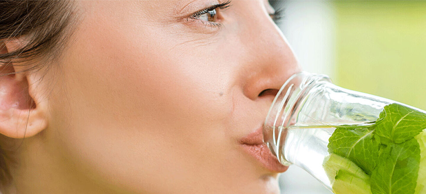 woman drinking water with mint