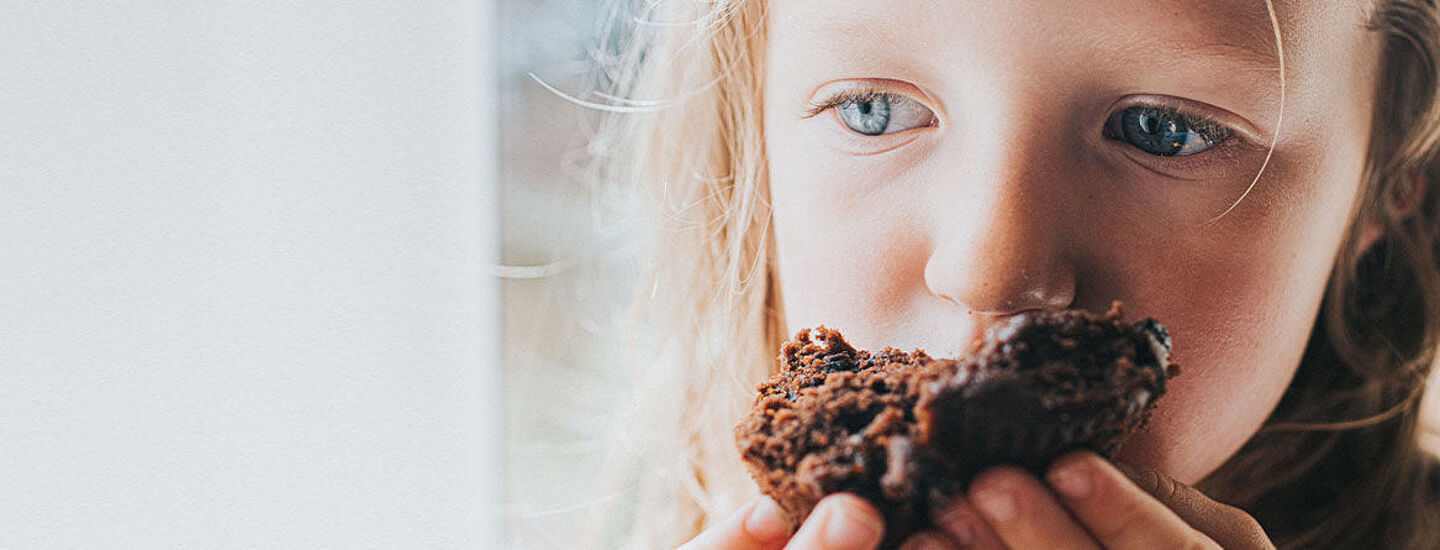 girl eating a piece of chocolate cake