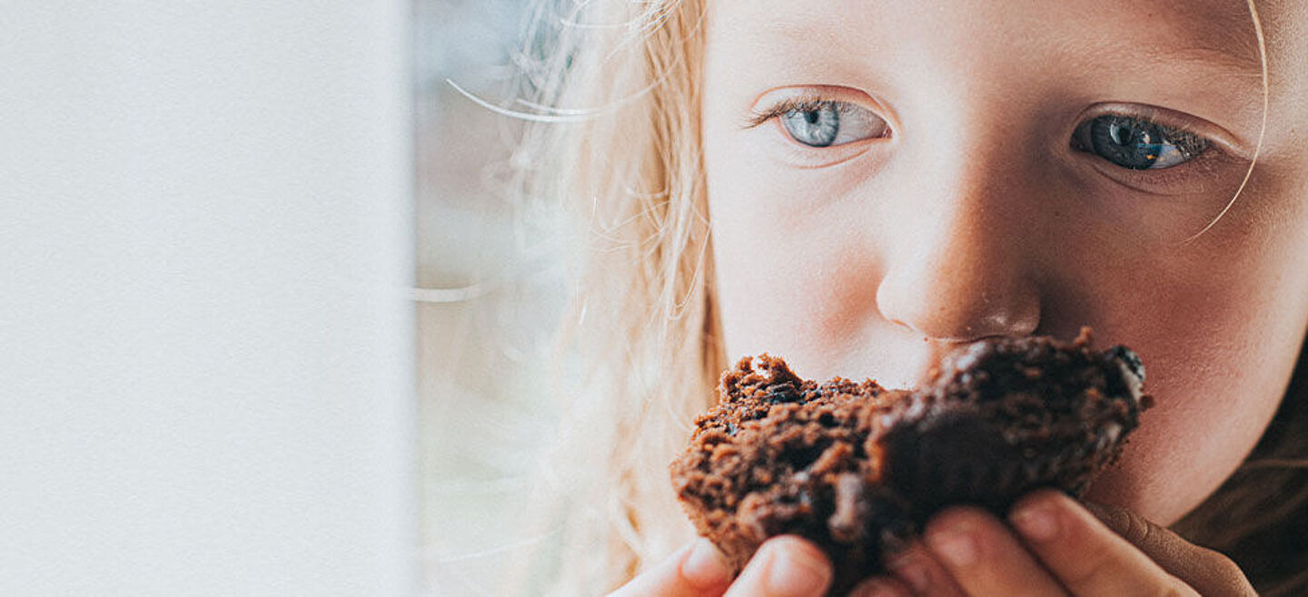 girl eating a piece of chocolate cake
