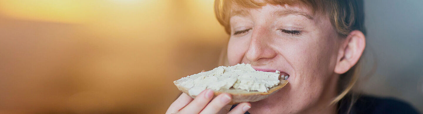 girl tasting a bit of food