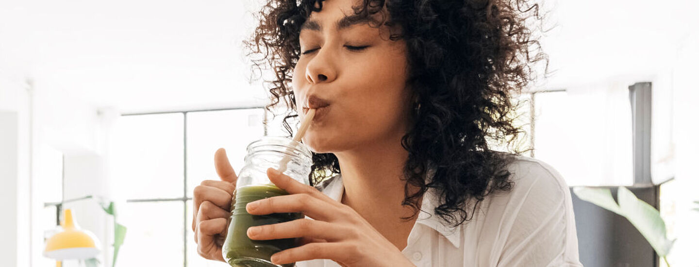 Mädchen trinkt grünen Saft