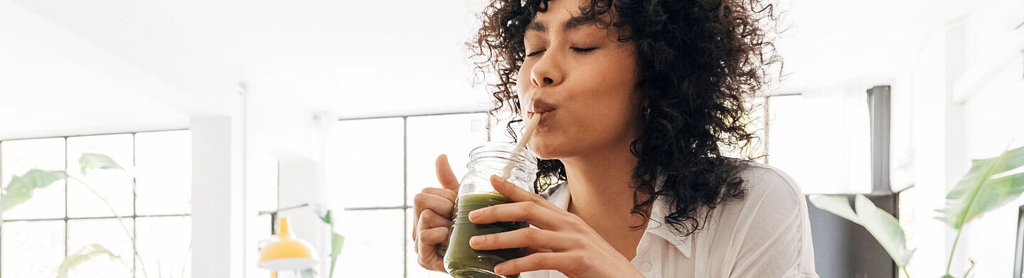 Mädchen trinkt grünen Saft