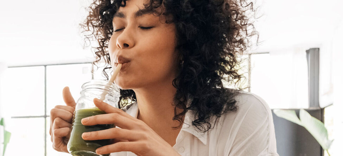 girl drinking green smoothie