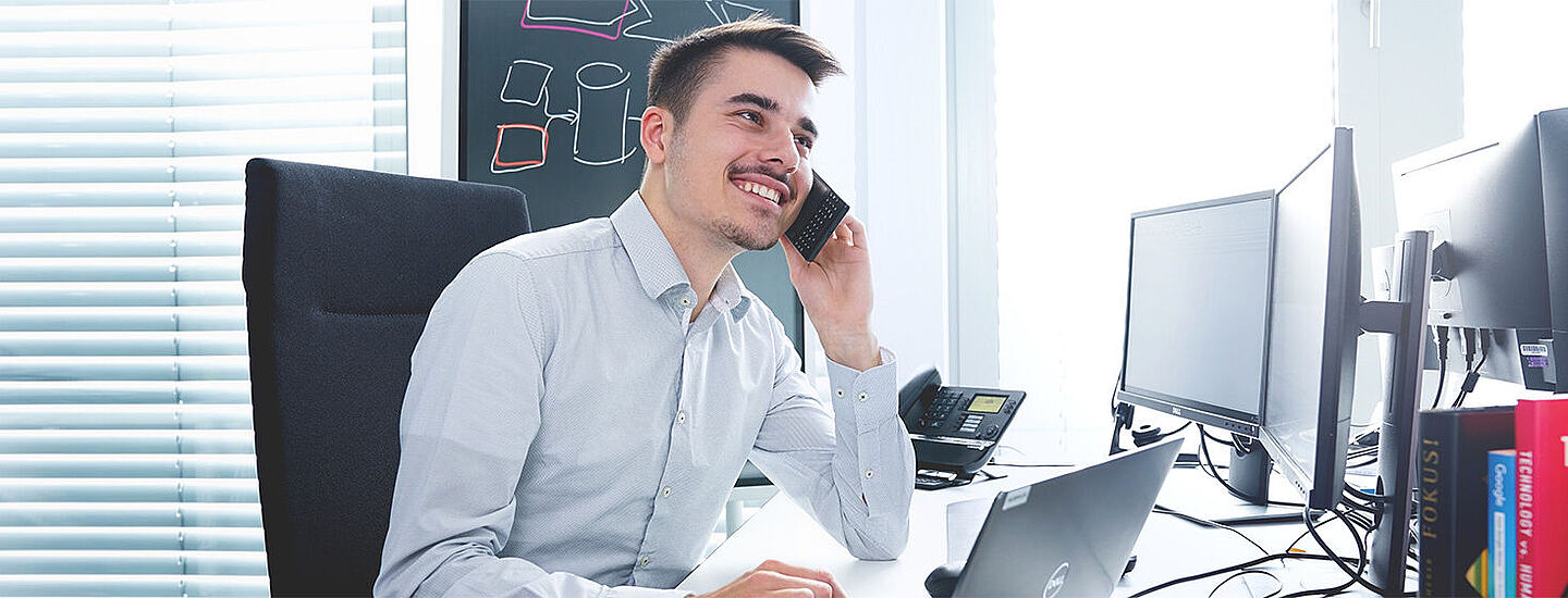 man on a desk having a conversation on the phone