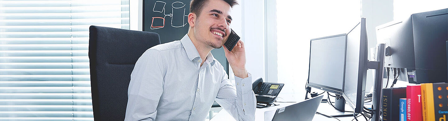 man on a desk having a conversation on the phone