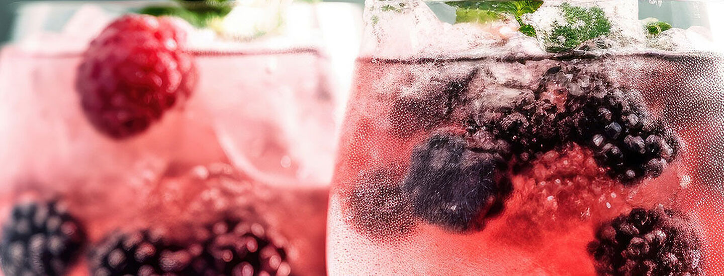 two glasses with water and red berries