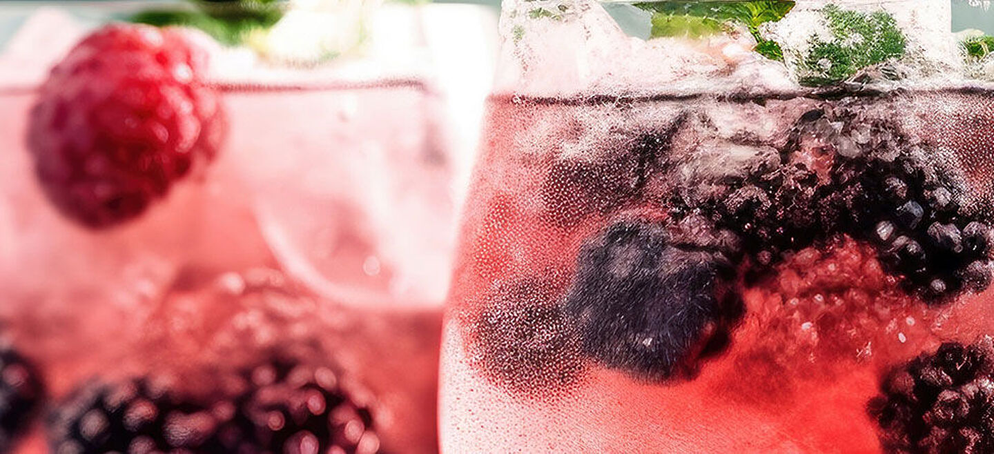 two glasses with water and red berries