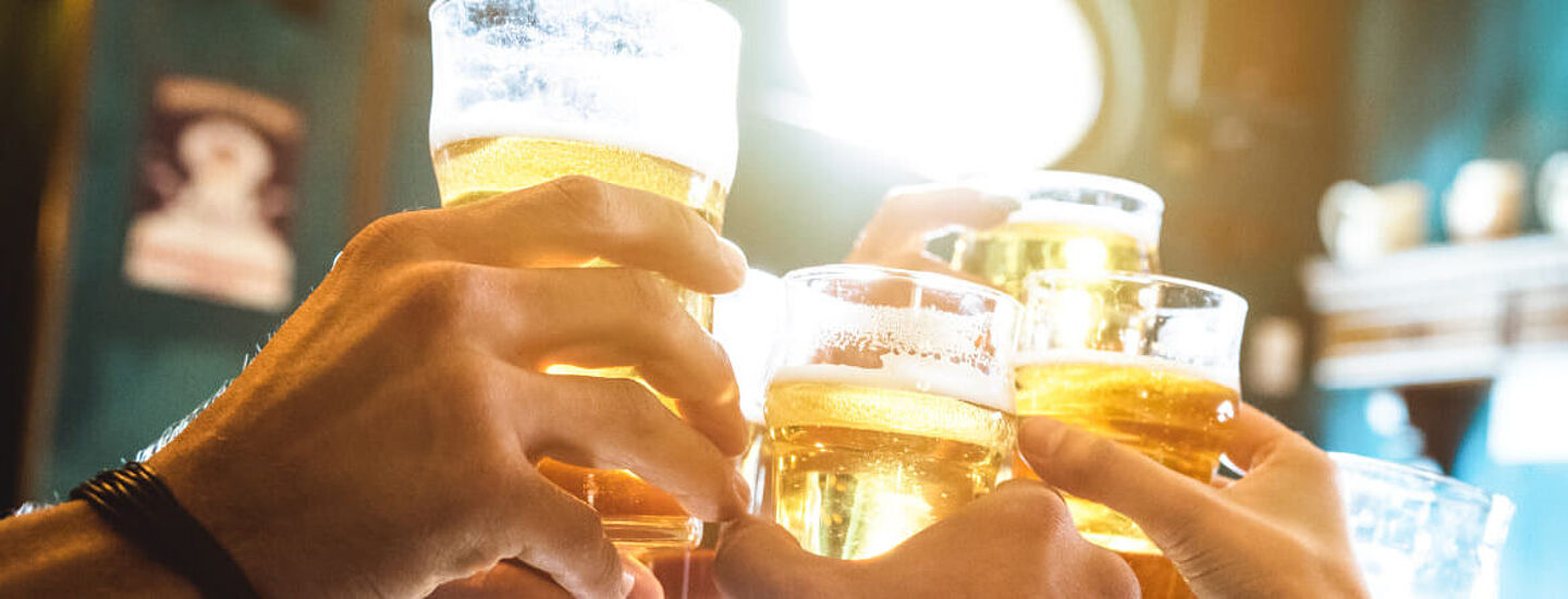 people toasting with beer