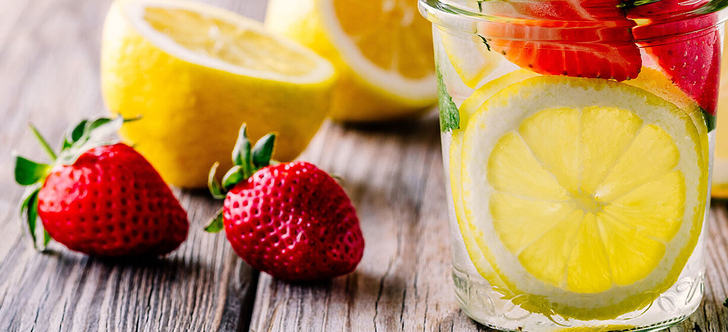 vaso con agua, limón y fresa