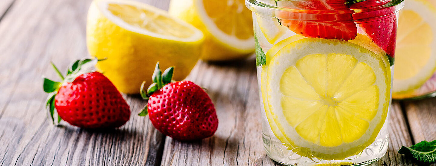 glass with water, lemon and strawberry