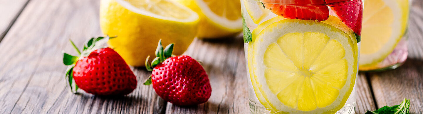 glass with water, lemon and strawberry