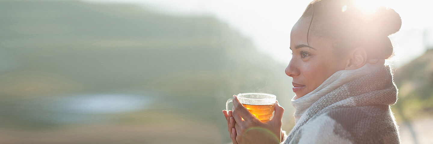 woman getting warm with a hot tea