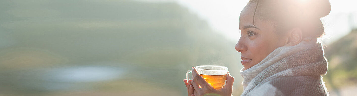 woman getting warm with a hot tea