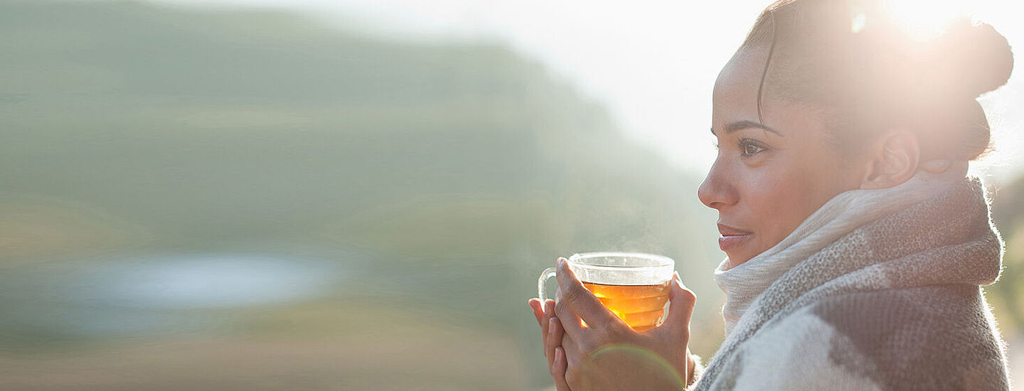 woman getting warm with a hot tea