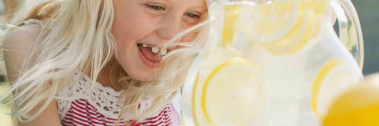 little girl with lemon water