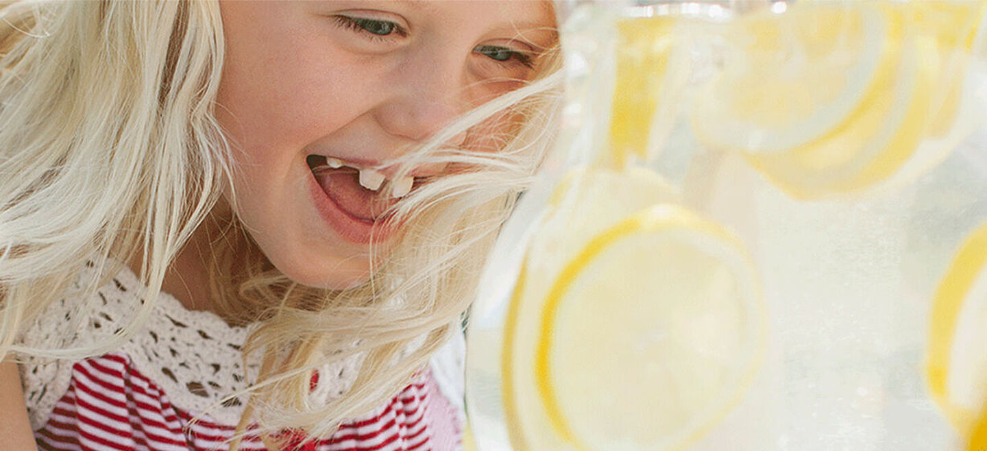 little girl with lemon water