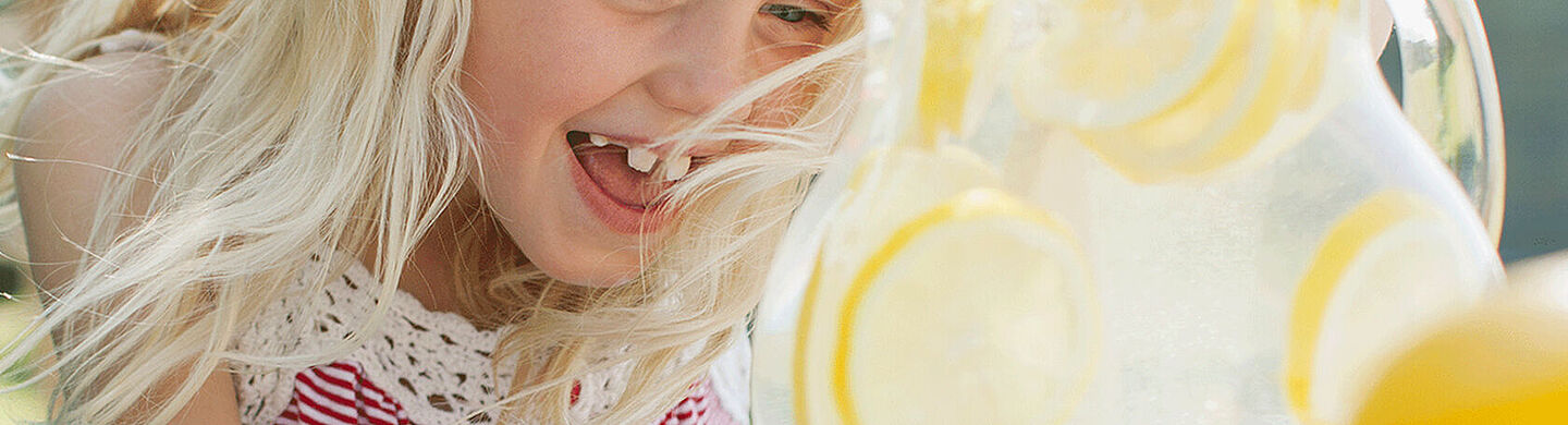 little girl with lemon water